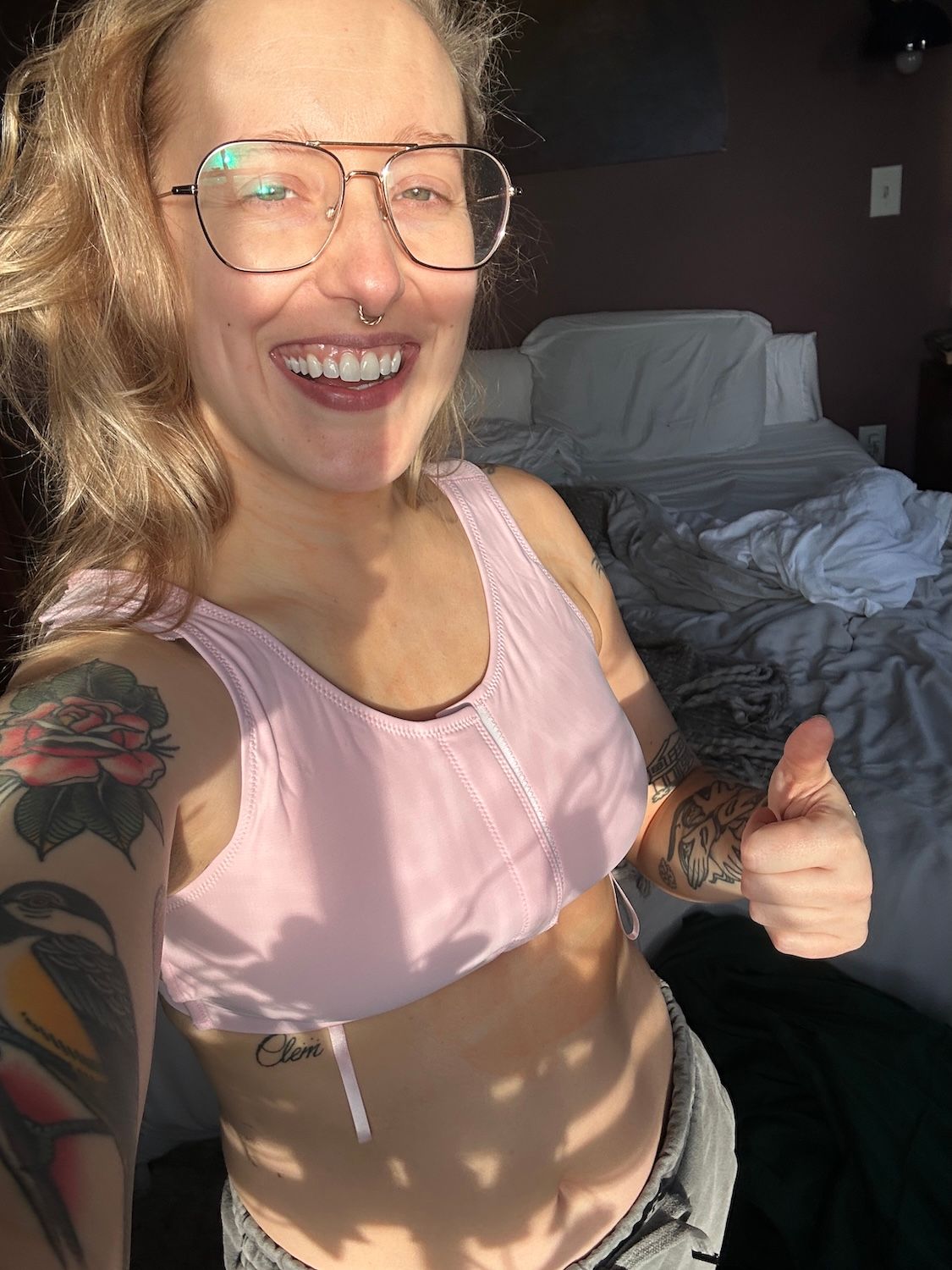 woman in a purple surgical bra after breast surgery