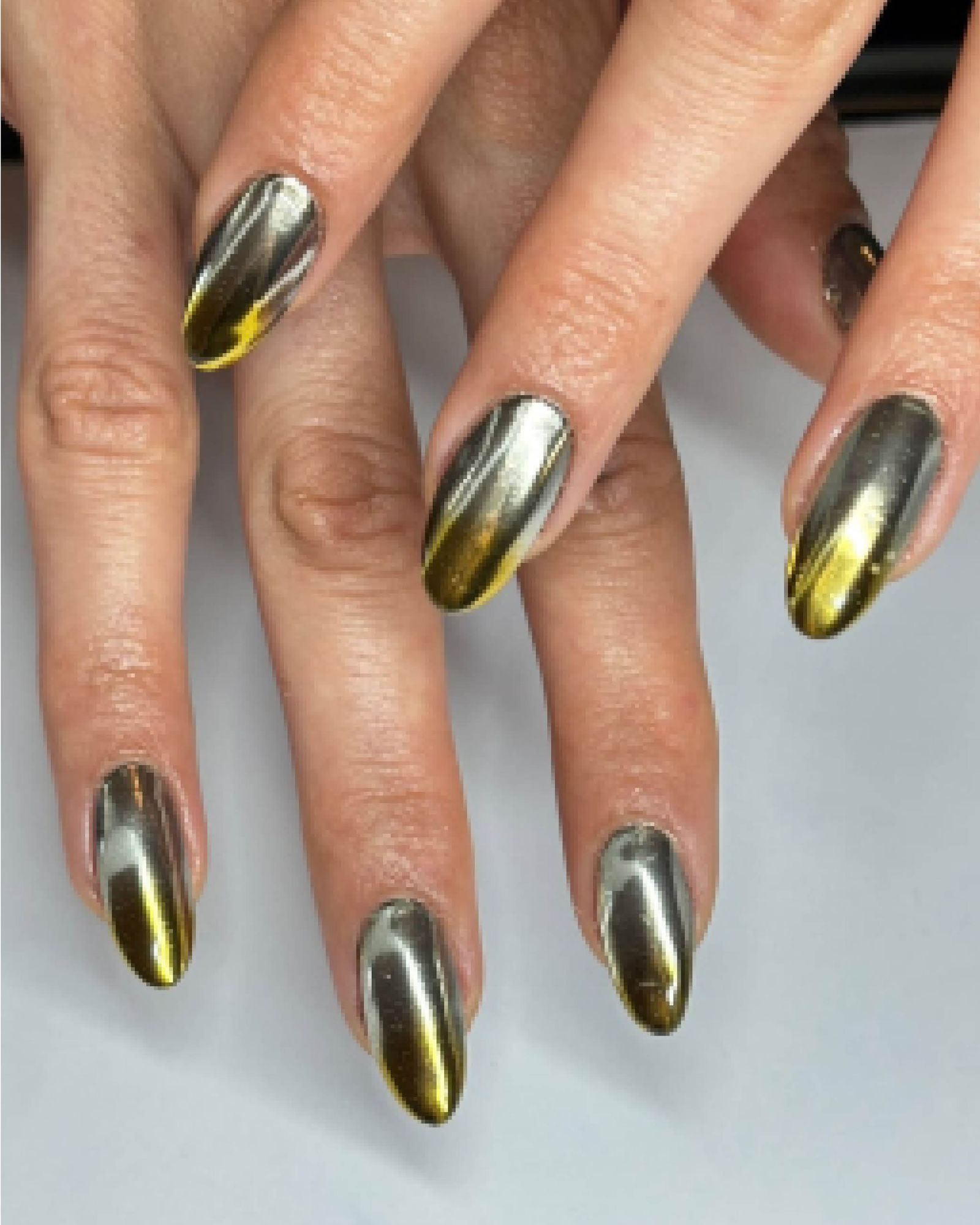 Silver and yellow gold shiny metallic almondshaped nails.