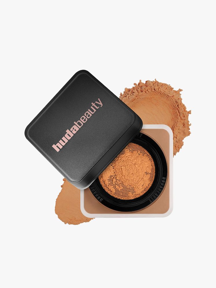 HUDA BEAUTY  Easy Bake Blurring Loose Baking  Setting Powder top view of a square jar of face powder on light gray...