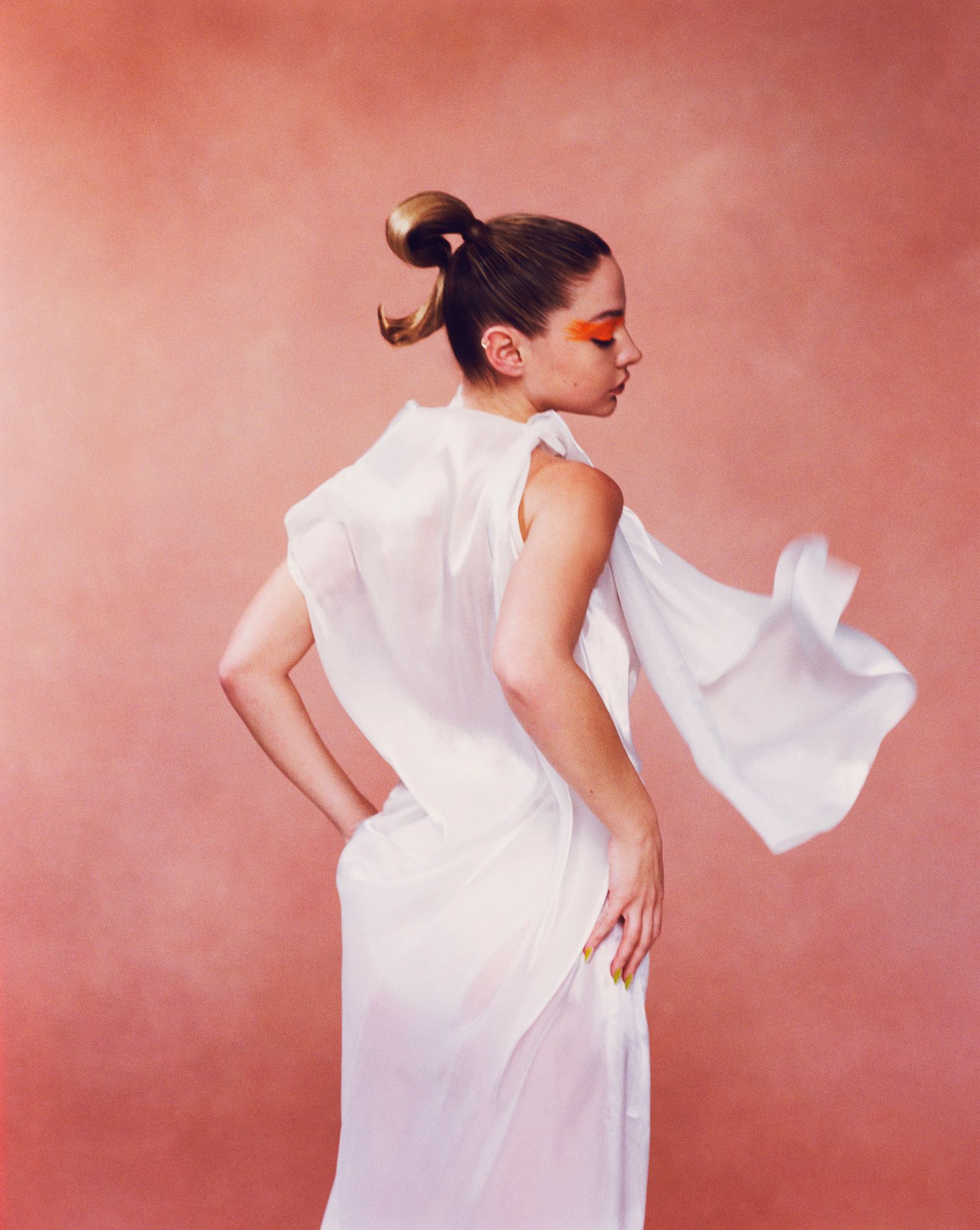 Madelyn Cline in white dress and orange eye makeup