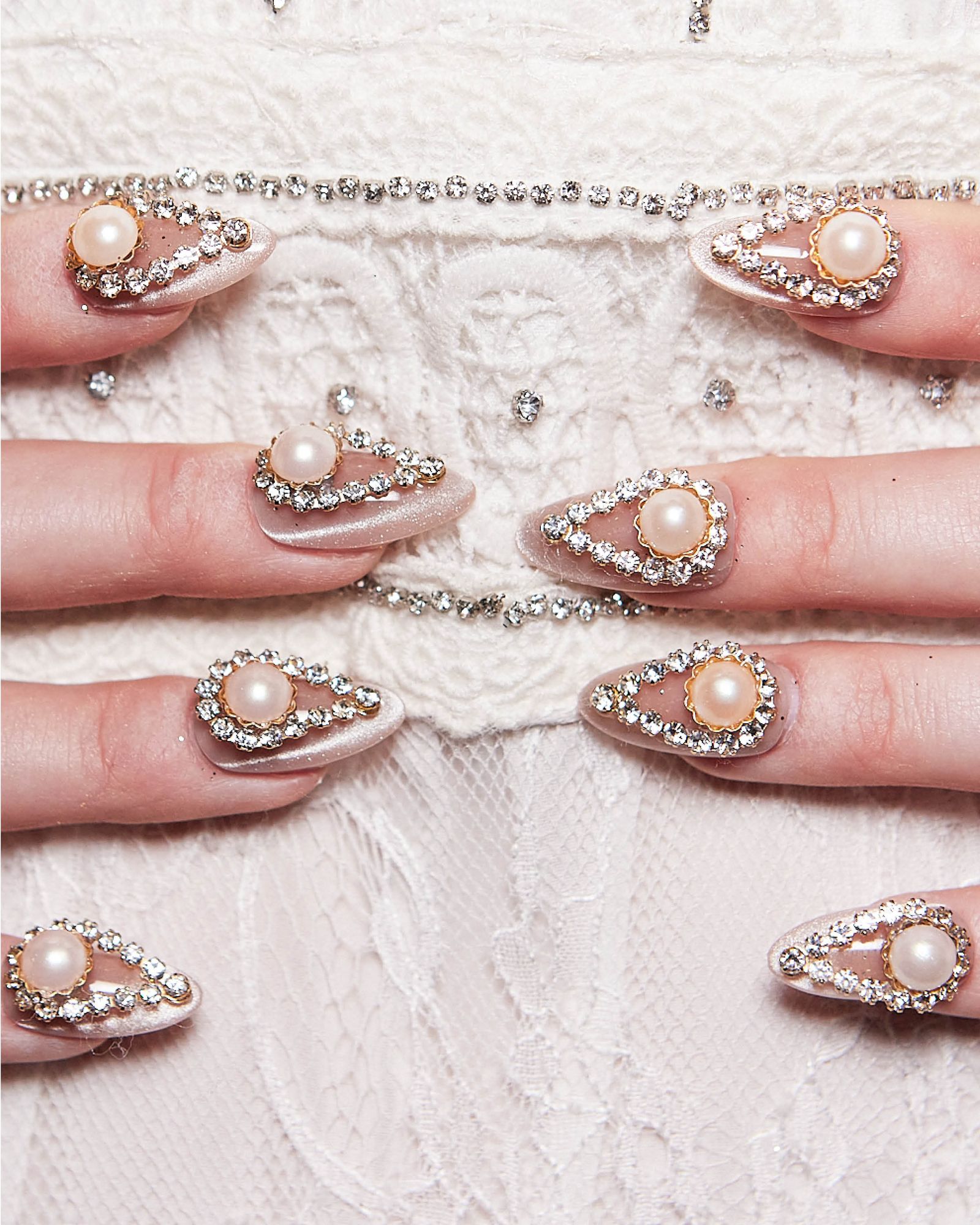 Gemencrusted teardrop nails with large pearl detail over lace.