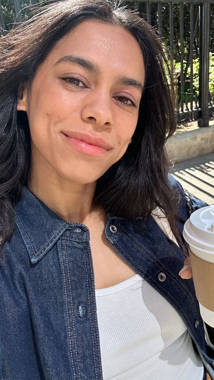 Image may contain Daya Vaidya Head Person Face Dimples Cup Black Hair Hair Adult Body Part and Neck