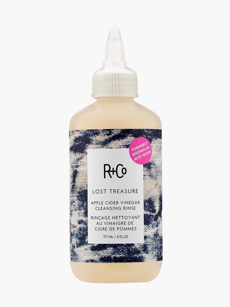 R+CO Lost Treasure Apple Cider Cleansing Rinse beige bottle with denim label and pointed dispenser tip on light gray background