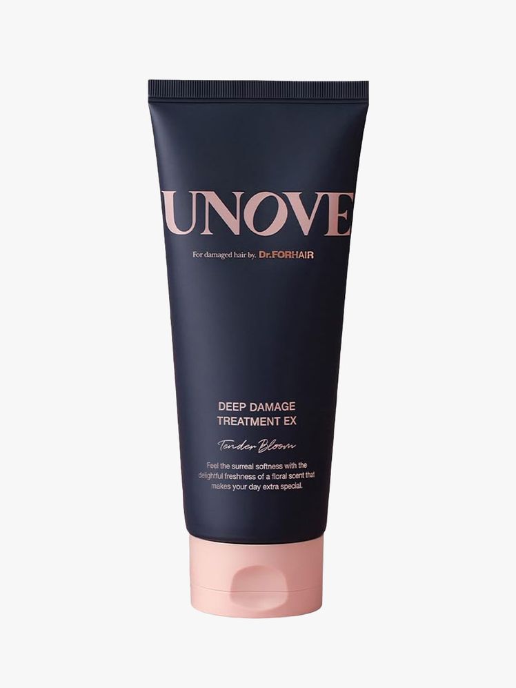 A navy tube of Unove Deep Damage Treatment Ex on light gray background