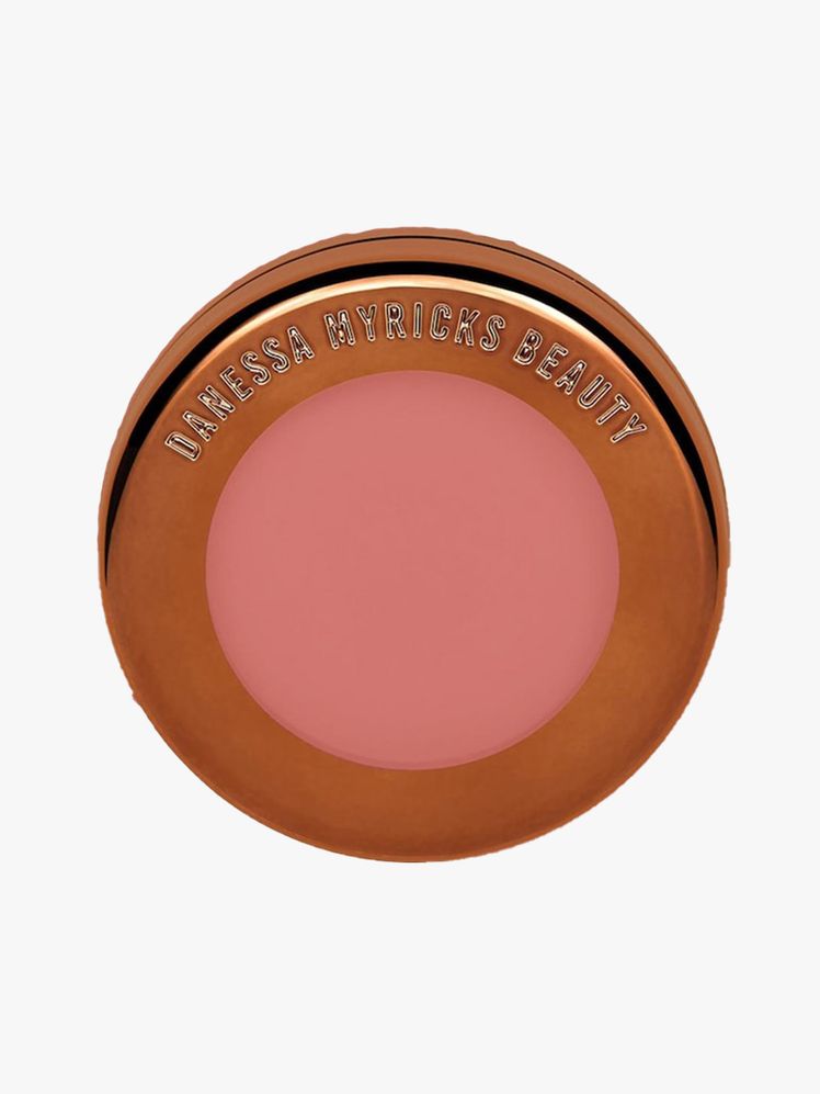 Yummy Skin Blurring Balm Powder Flushed in Rosé N Brunch round bronze compact of pink blush balm on light gray background