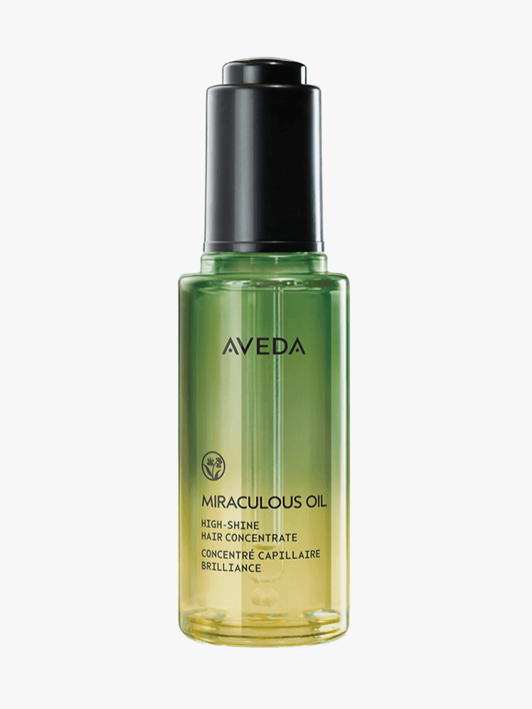 Aveda Miraculous Hair Oil in branded component on a light gray background