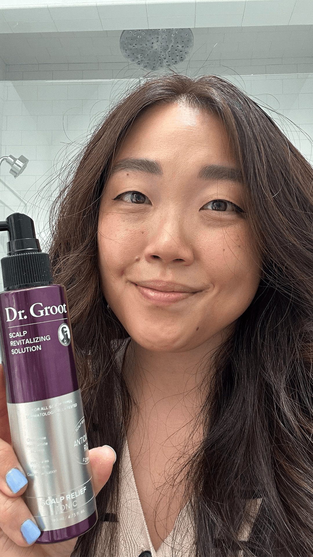 Selfie of Contributing commerce writer Christa Joanna Lee after applying Dr. Groot Scalp Relief Tonic