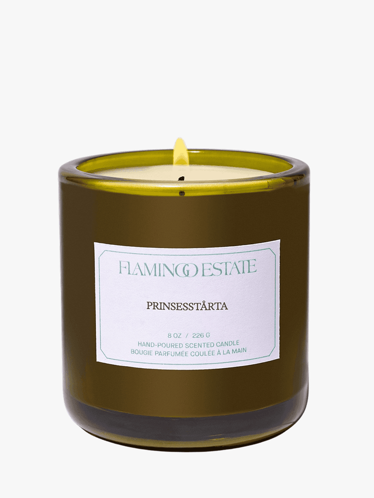 Flamingo Estate Prinsesstarta Candle lit up on a grey background